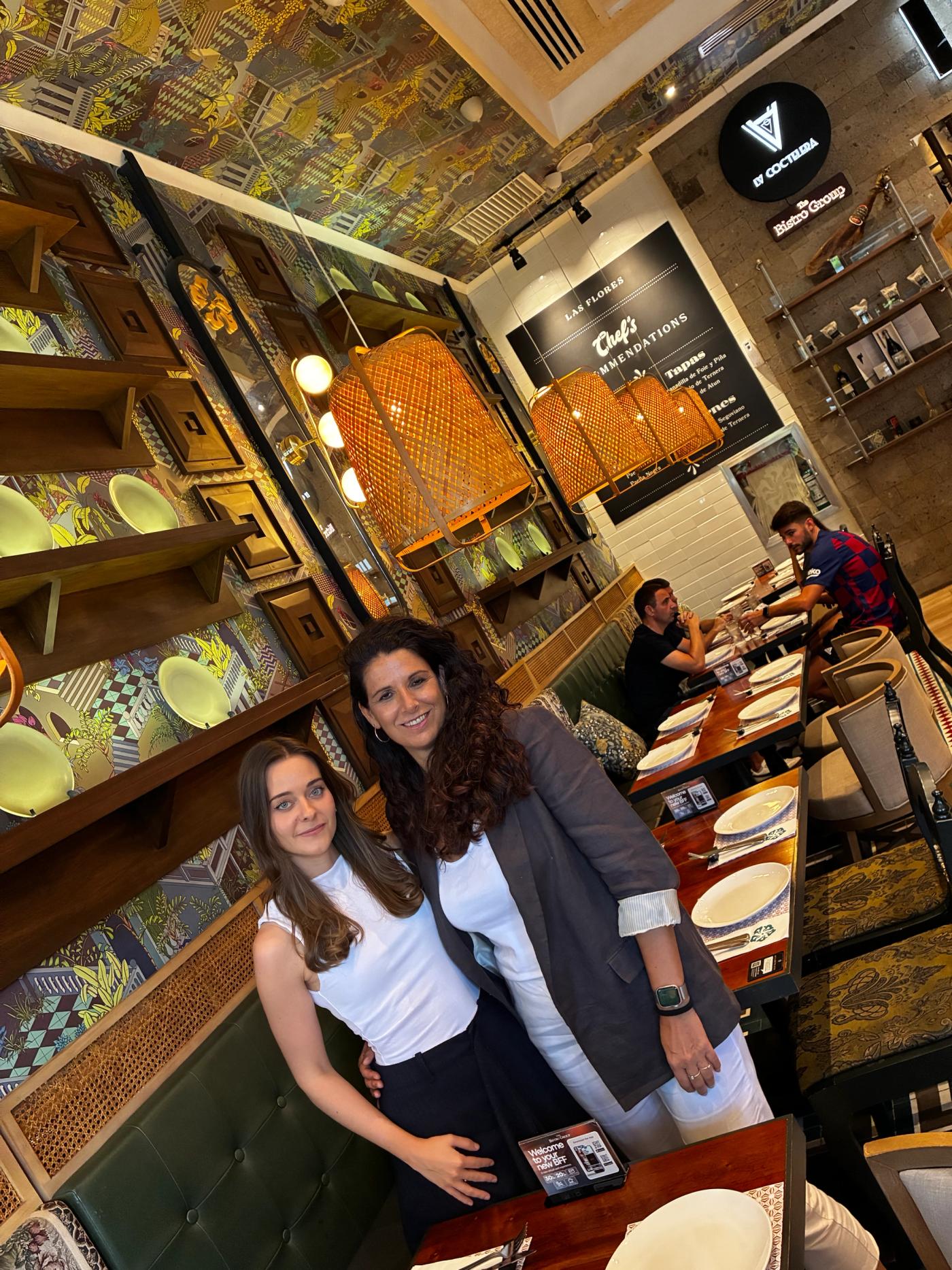 Brand ambassadors Marta Aranda Banos and Cristina Garcia-Villalba Marba in a dining room hung with woven lamps
