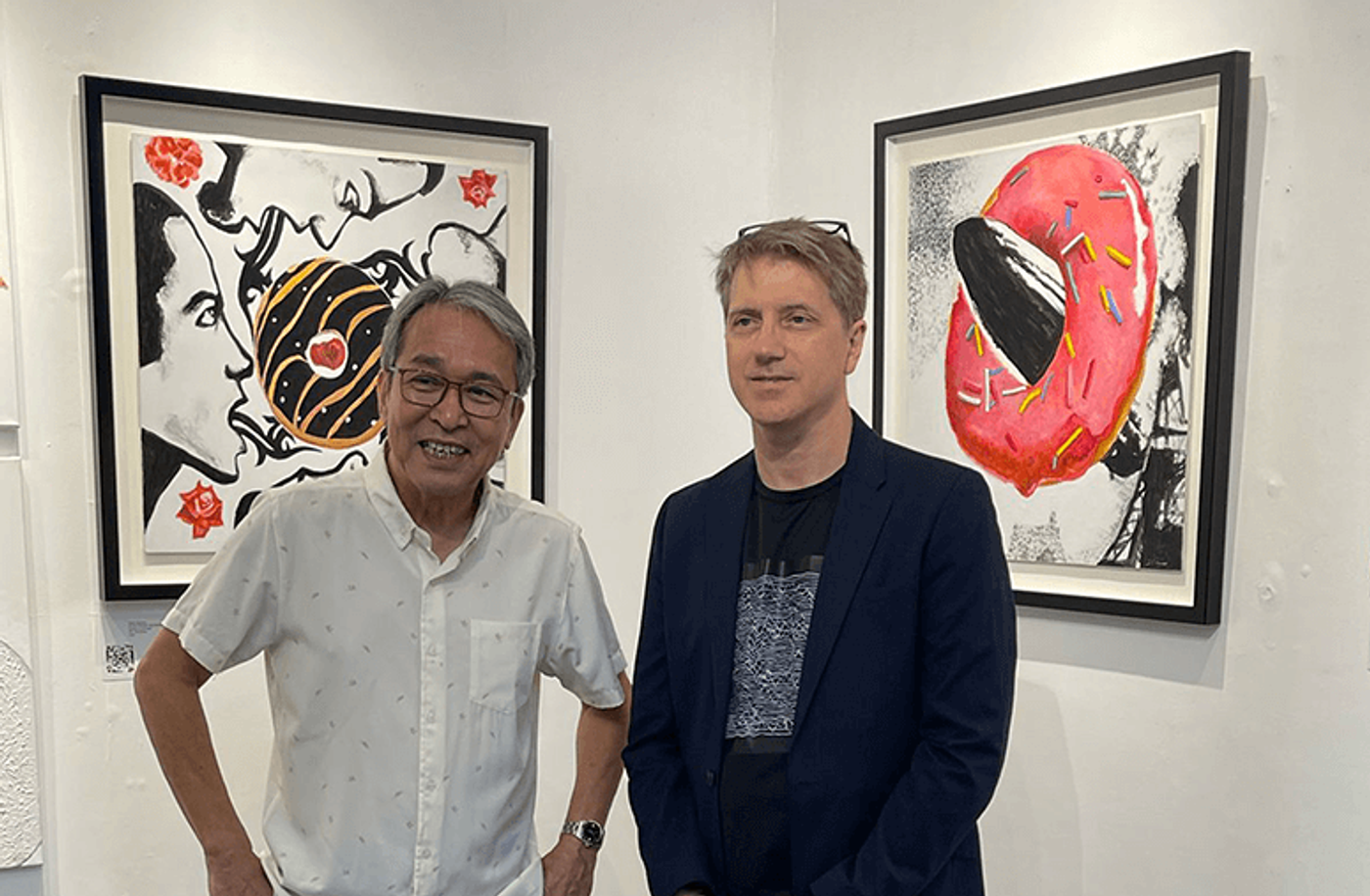 Crucible Gallery owner Sari Ortiga and artist Scott Garceau standing side-by-side inside the gallery space
