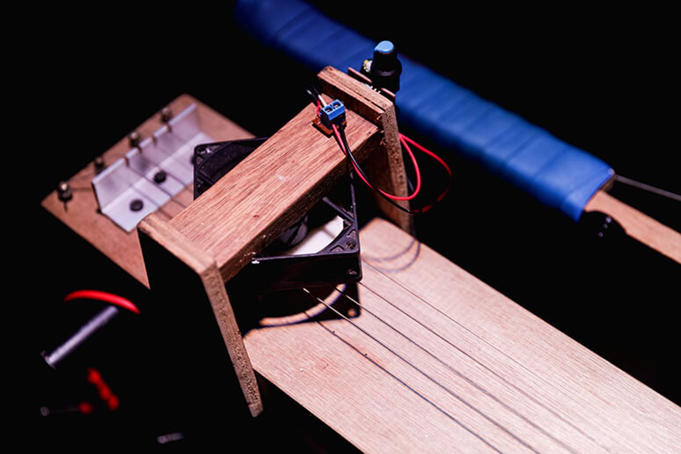 Close-up of the Hinangin instrument, an aeolian-harp lap steel guitar with spinning magnets and strings