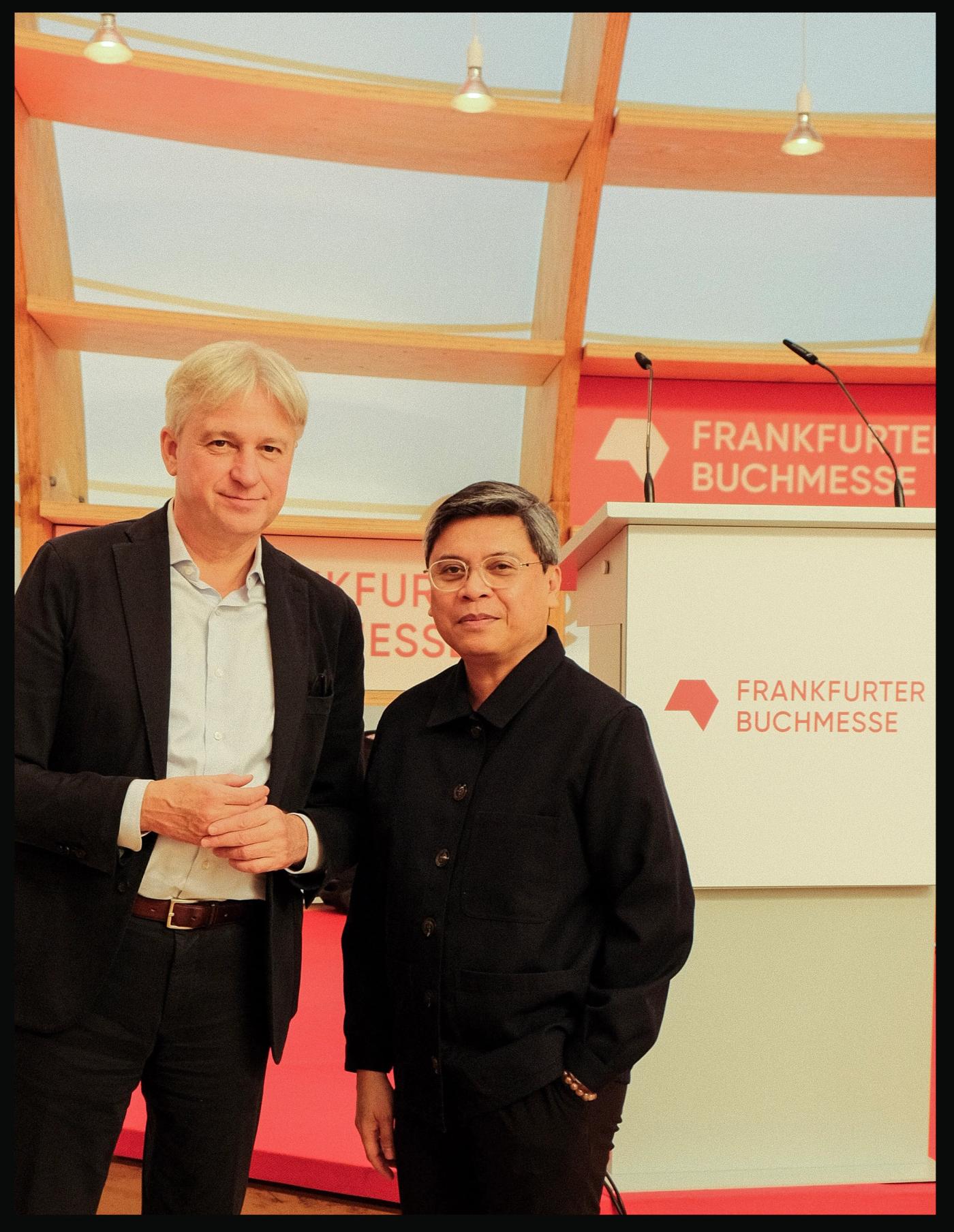 Frankfurt Book Fair director Juergen Boos and Philippine Pavilion curator Patrick Flores posing together next to a lectern