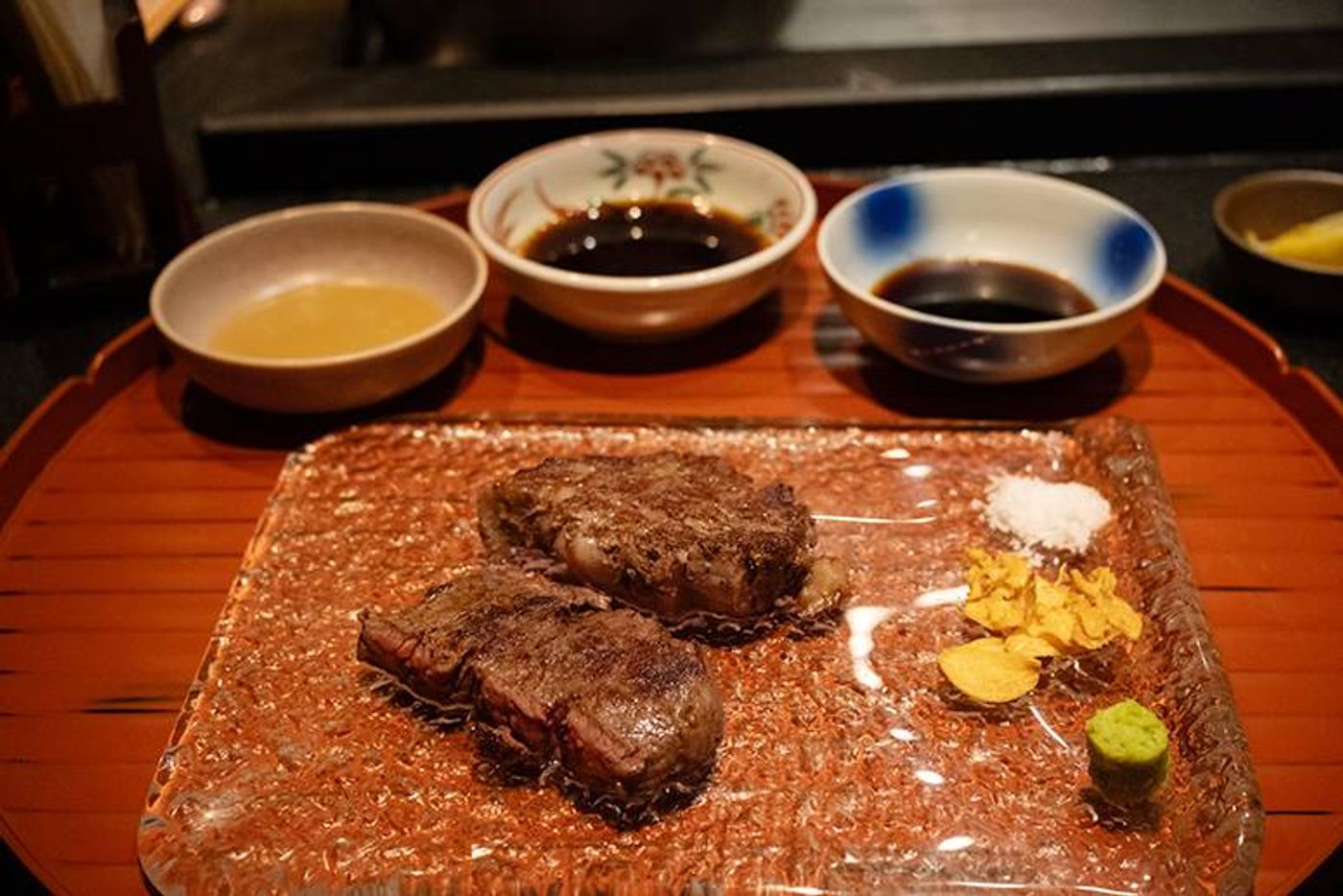 Seared cubes of Japanese F1 tenderloin with salt, garlic chips and wasabi at the teppanyaki counter