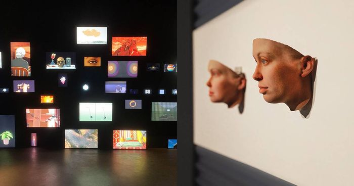 Small glowing video screens filling a dark gallery wall beside sculpted 3D face fragments at the Singapore Art Museum
