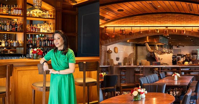 Ana de Ocampo in a green dress at the bar beside a view of Osteria Antica’s wood-vaulted dining room