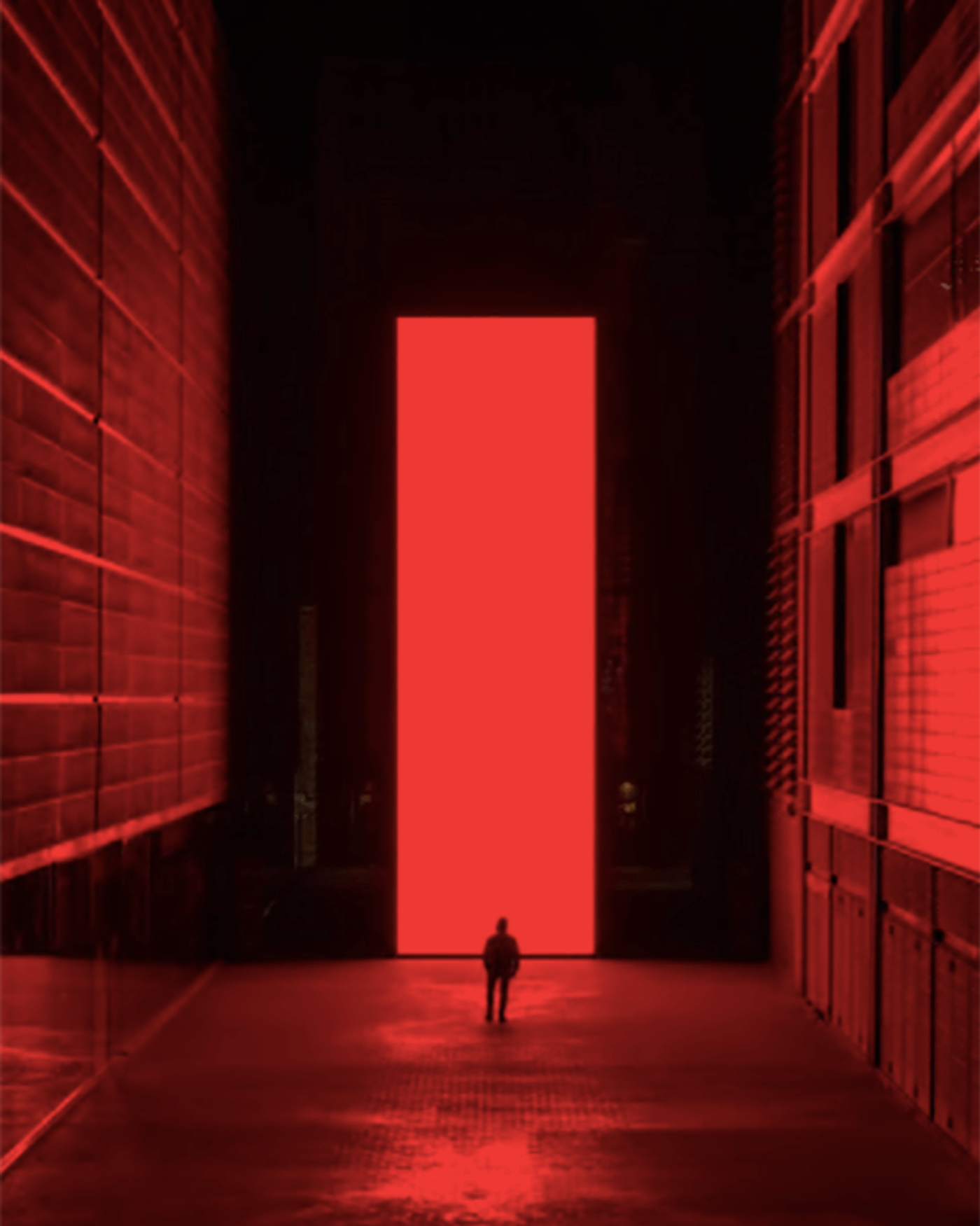 The illuminated tower “Monolith” glows like a giant screen against the Barcelona night