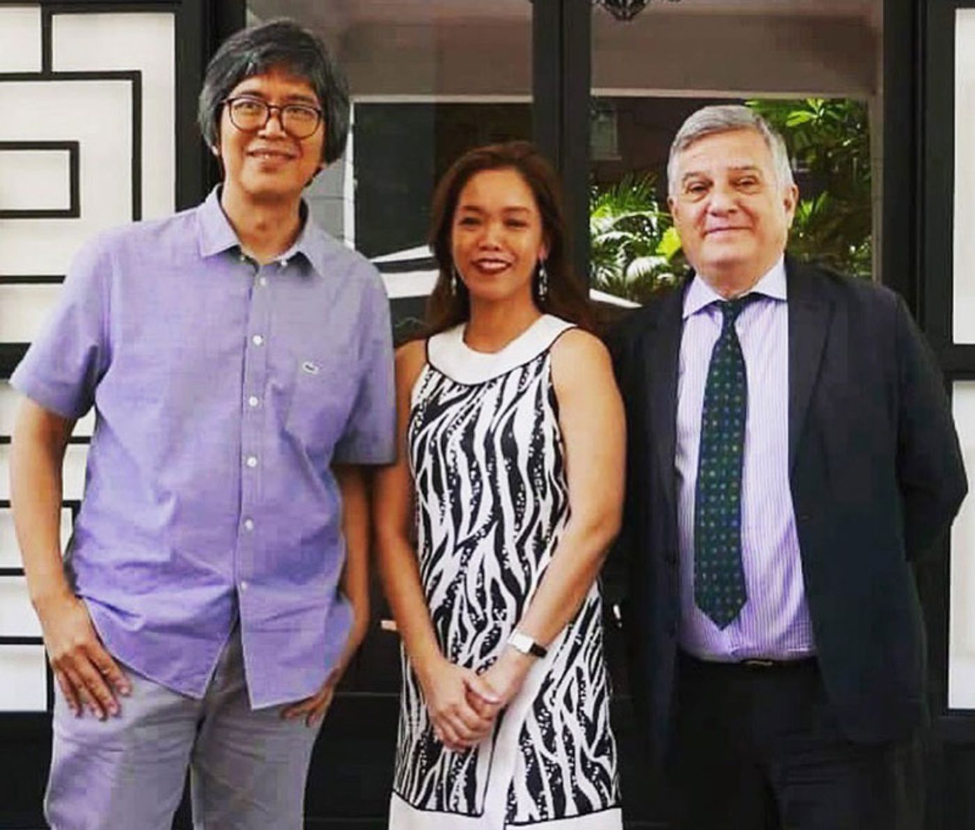 Artist Mark Justiniani, curator Tessa Maria Guazon, and Italian Ambassador Giorgio Guglielmino posing together at a press event