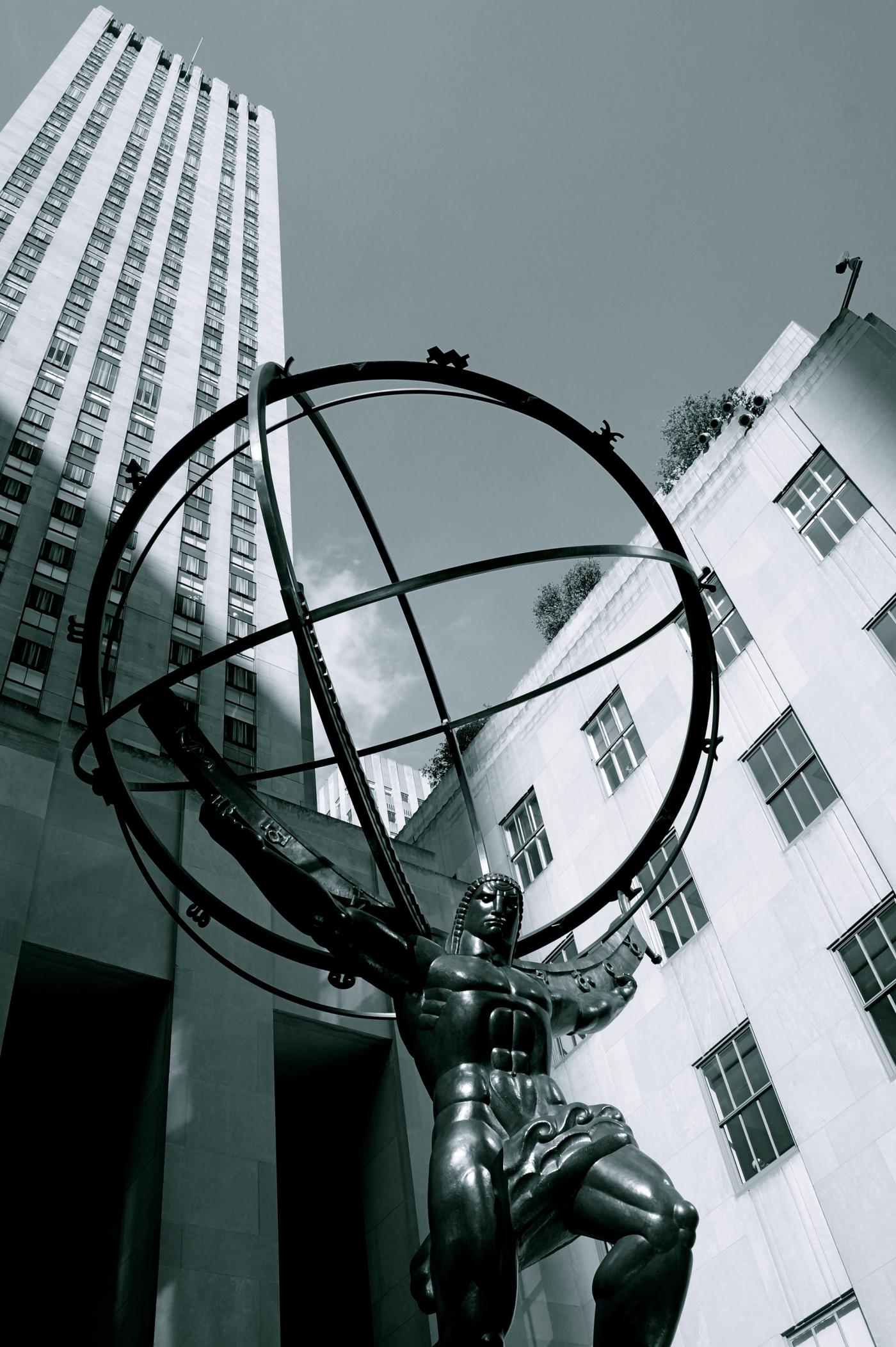 Bronze Atlas statue hoisting an open celestial sphere between Rockefeller Center towers