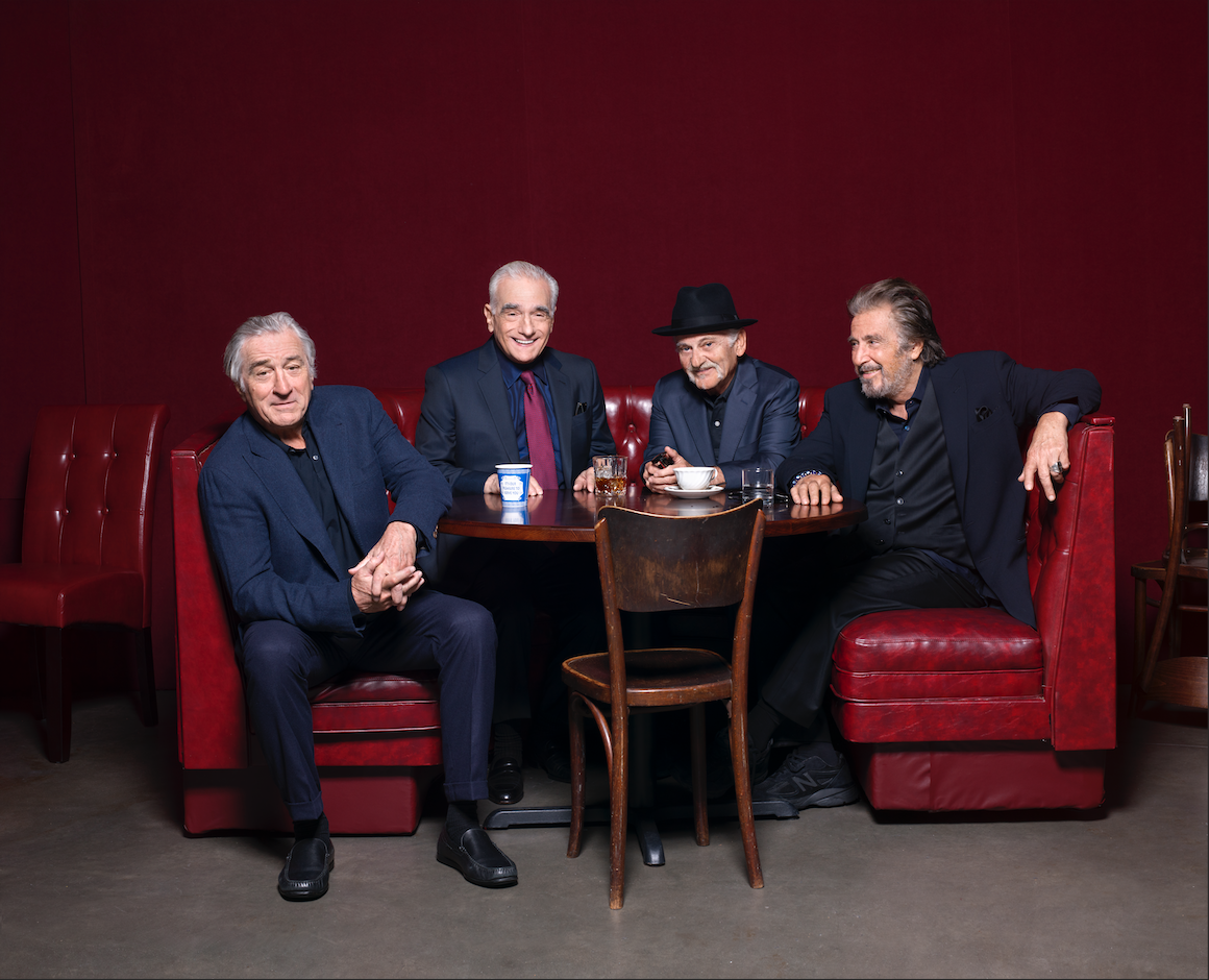 De Niro, Scorsese, Pesci and Pacino pose around a small table flanked by red leather banquettes