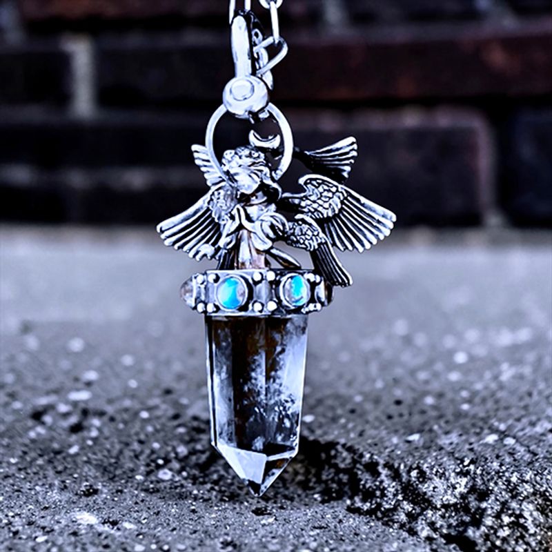 Oxidized silver pendant by Michelline Syjuco with a winged angel perched on a clear quartz crystal point