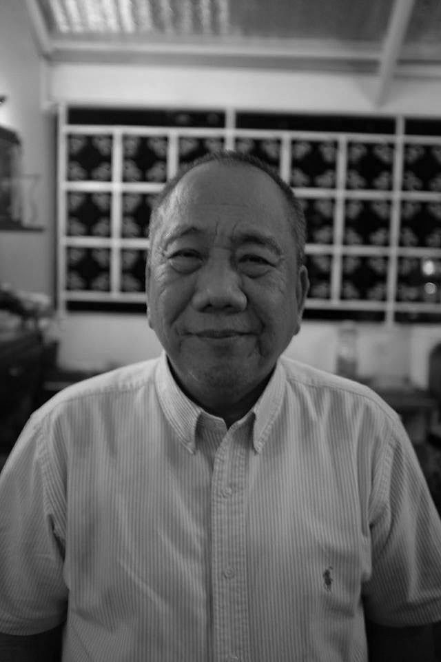 Boy Vinzon in a white shirt, smiling inside a bar