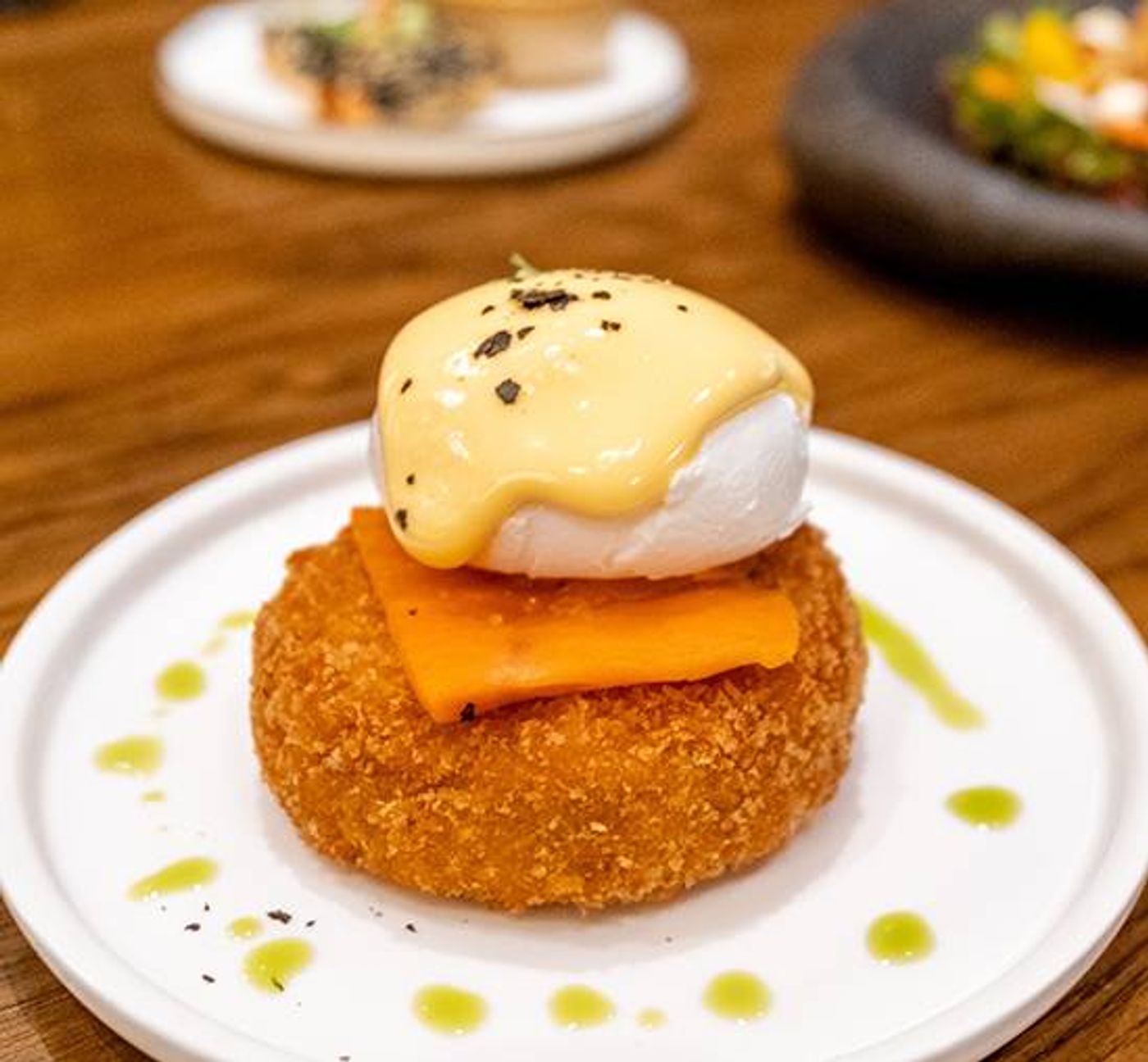 Crispy crab cake stacked with smoked salmon and a poached egg draped in Hollandaise sauce