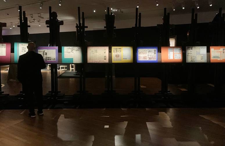David Medalla’s Kumbum Banners: a row of backlit colorful panels viewed by a lone visitor in the dark