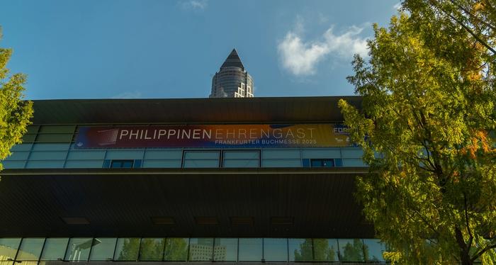 Philippinen Ehrengast banner on the Frankfurt fair hall with the Messeturm tower rising behind