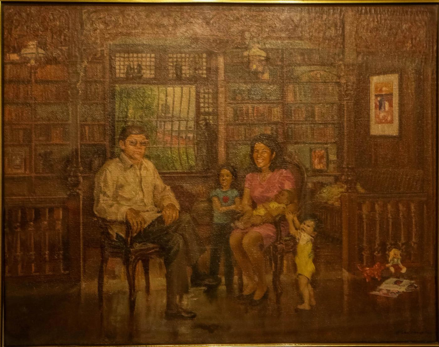 A painted family portrait set in a library, a man seated at left and a woman with three children at right, bookshelves filling every wall