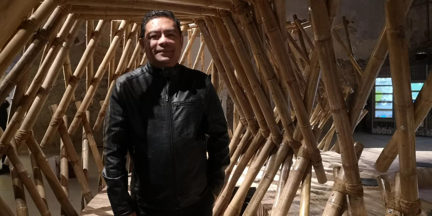 NCCA commissioner Arvin Manuel Villalon stands inside the bamboo lattice tunnel installation at the Venice Arsenale