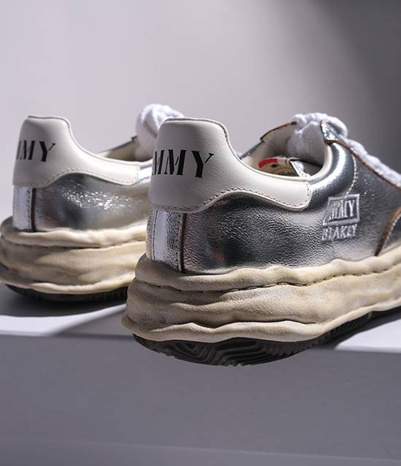 Detailed shot of silver Maison Mihara Yasuhiro Blakey sneaker showcasing the chunky white clay-like textured rubber sole