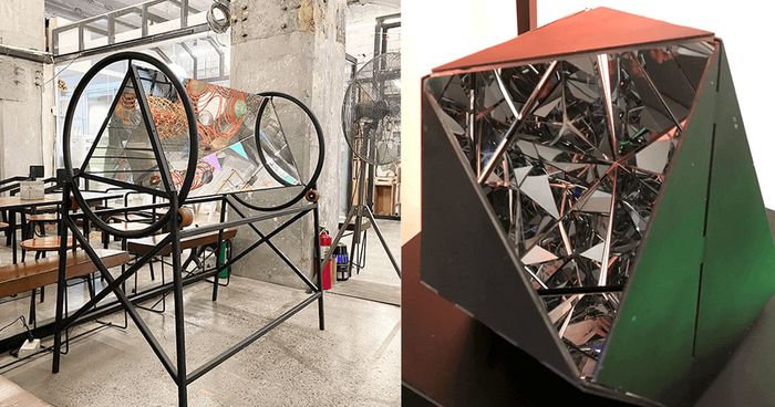Two works by Marco Ortiga: a black steel hoop sculpture and a faceted polyhedron lined with mirror shards
