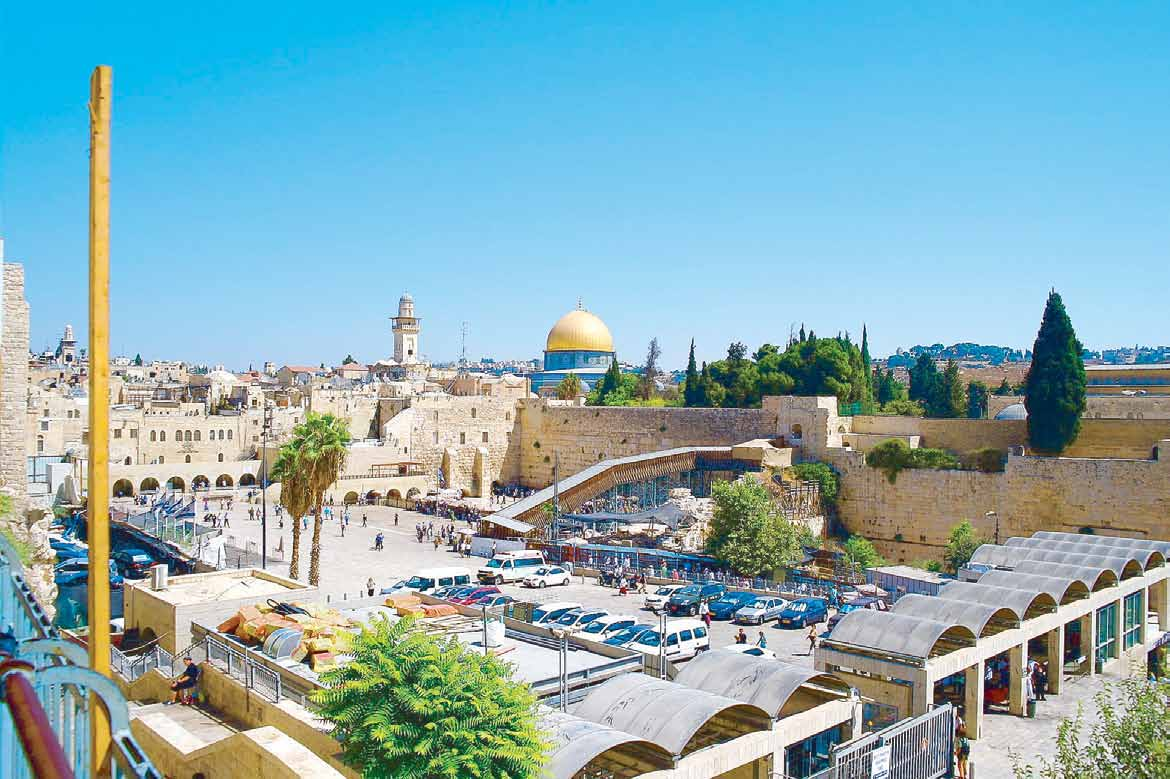The gold Dome of the Rock rising above the Western Wall and rooftops of Jerusalem’s Old City