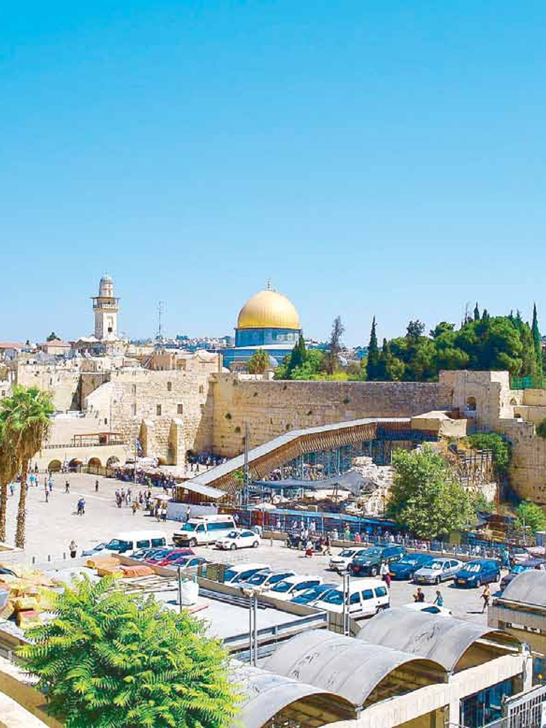 The gold Dome of the Rock rising above the Western Wall and rooftops of Jerusalem’s Old City