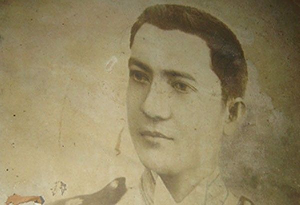 Faded sepia studio portrait of the young General Martín Delgado in uniform, the print cracked and flaking at one corner