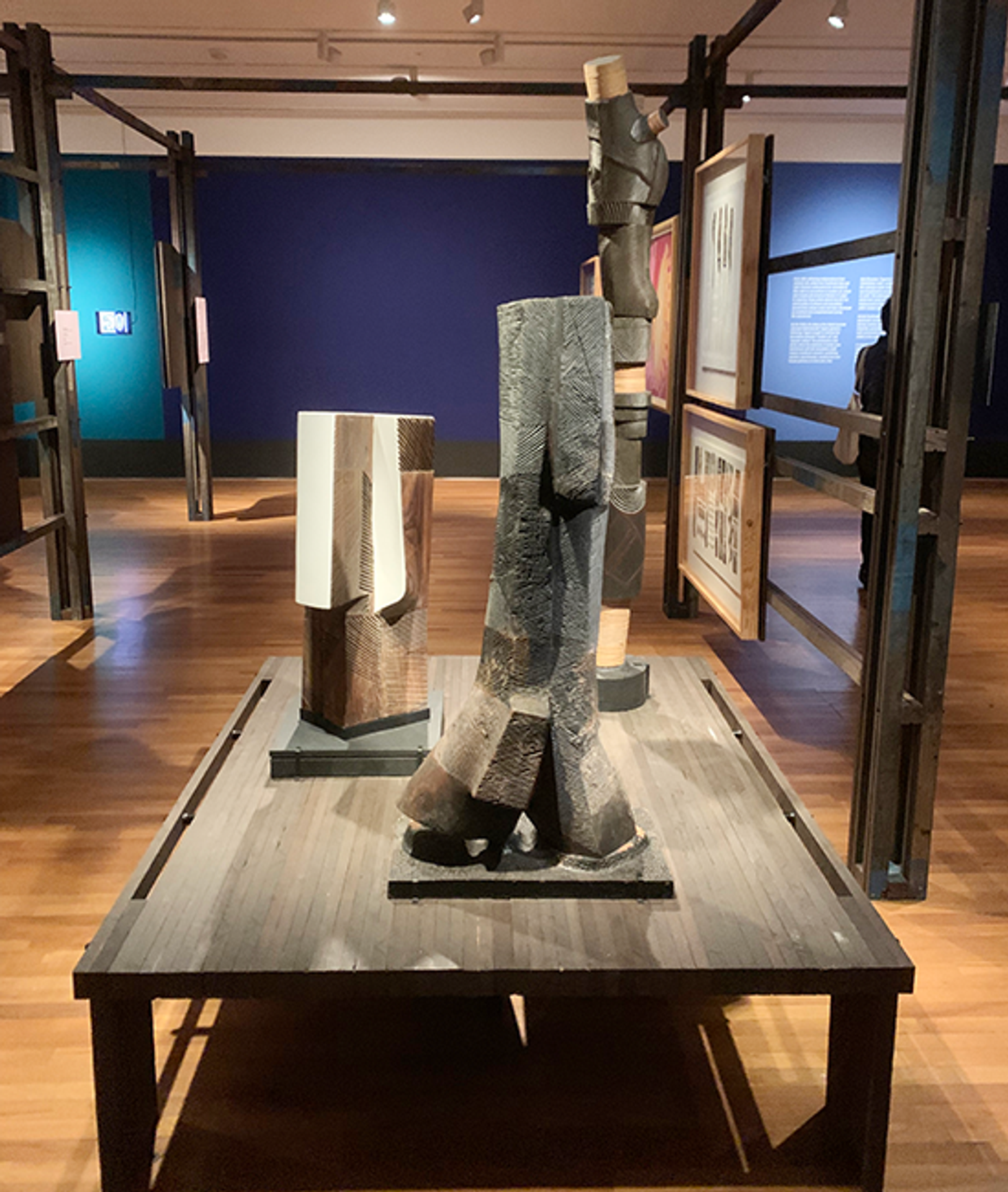 Sunaryo’s carved torso sculptures displayed on a low wooden platform in the gallery