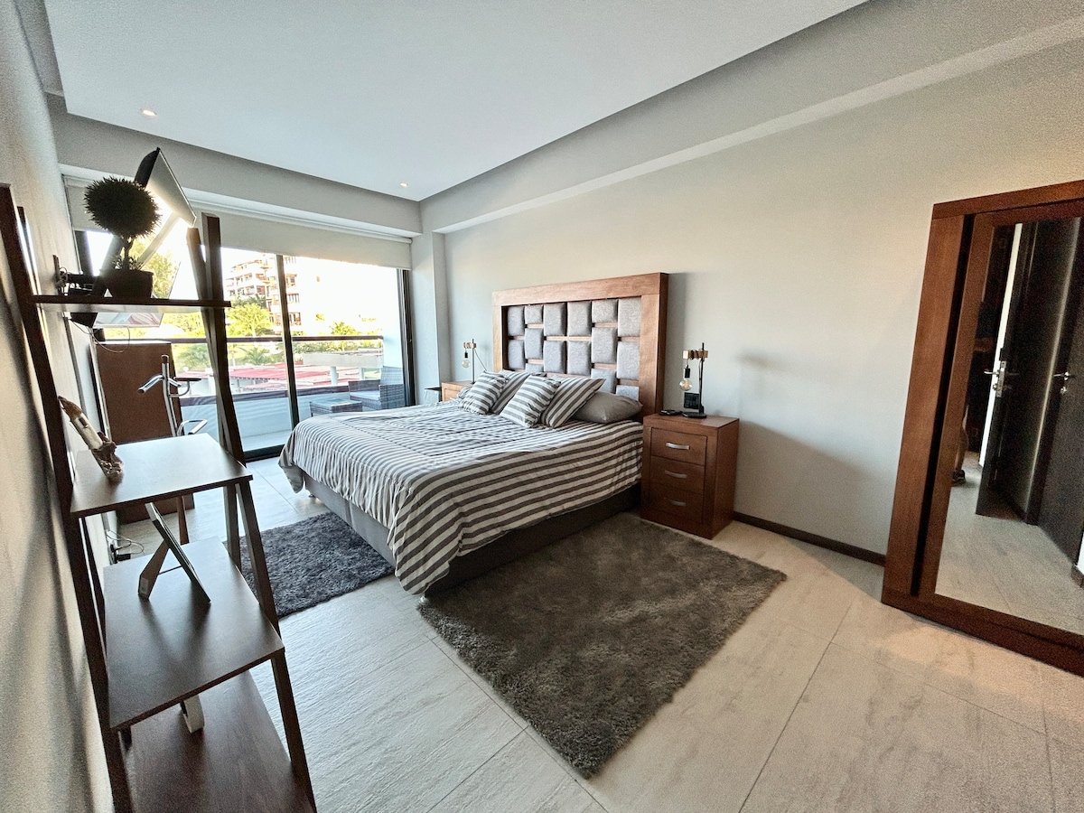 Primary bedroom with king bed and Smart TV
