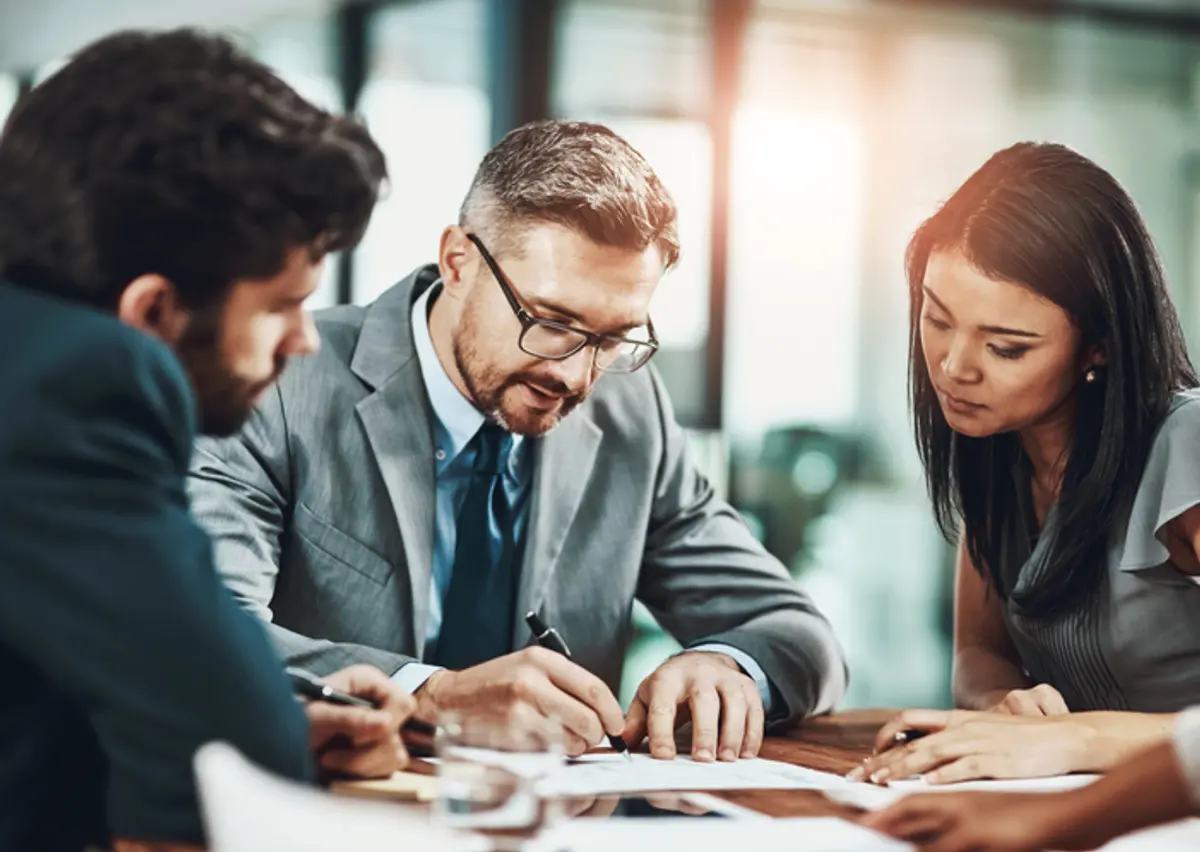 two men and one woman in a meeting