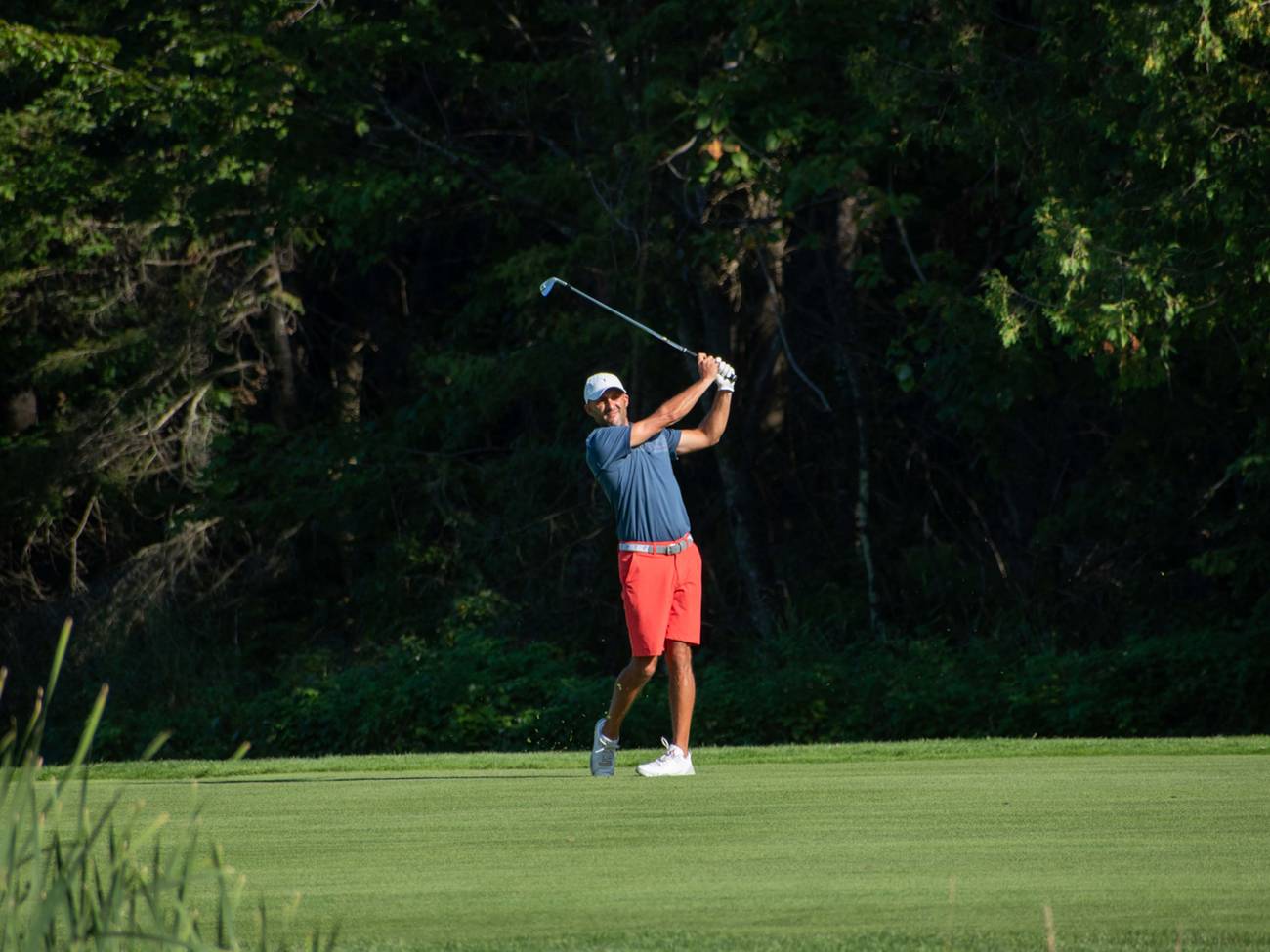 Golfer hitting iron