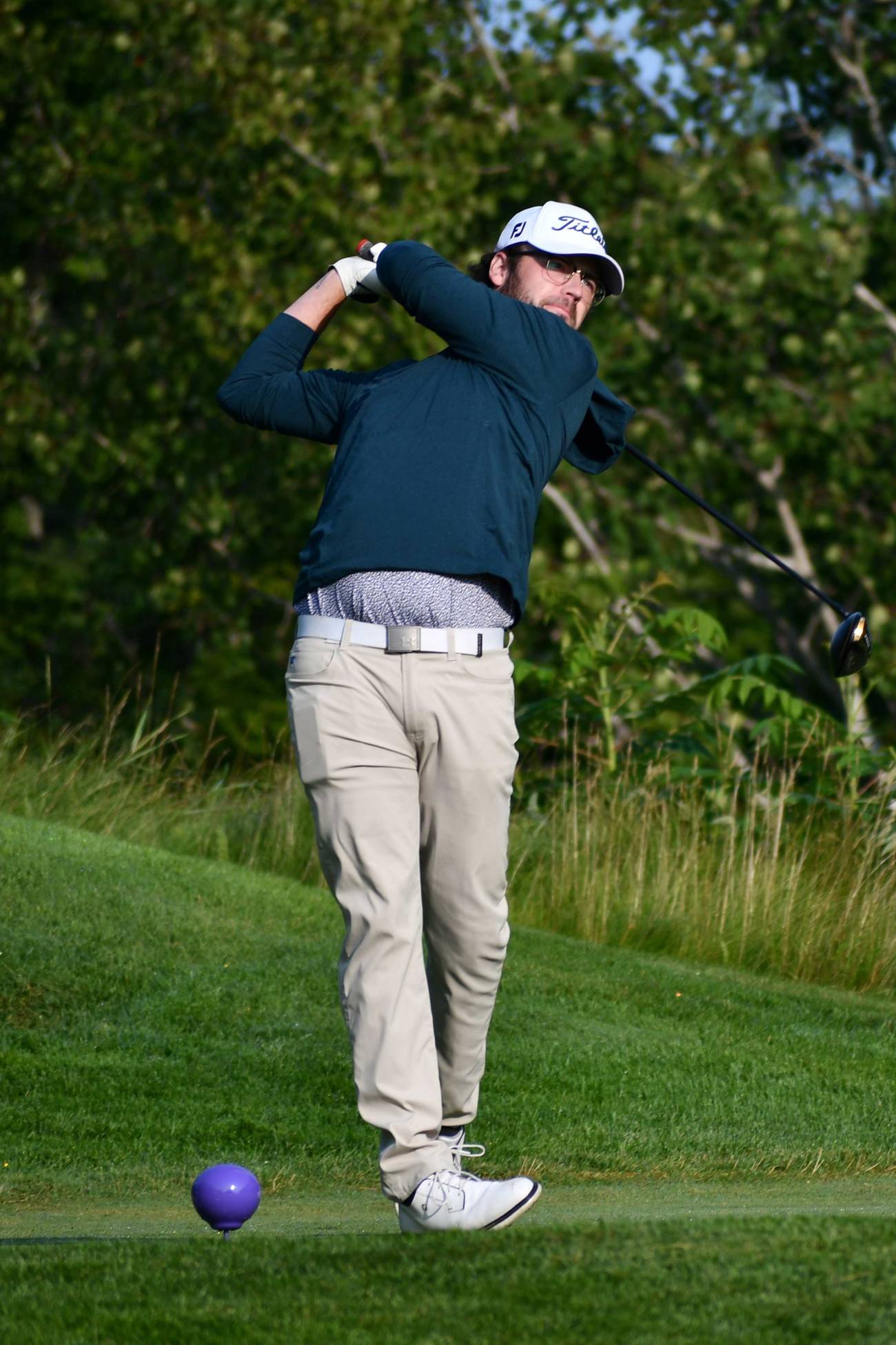 Golfer teeing off