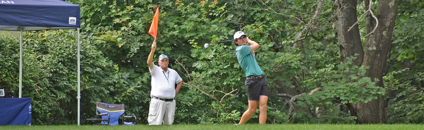 Golfer teeing off on first tee