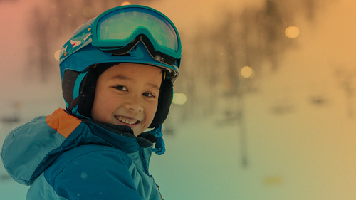 A child in ski gear posing