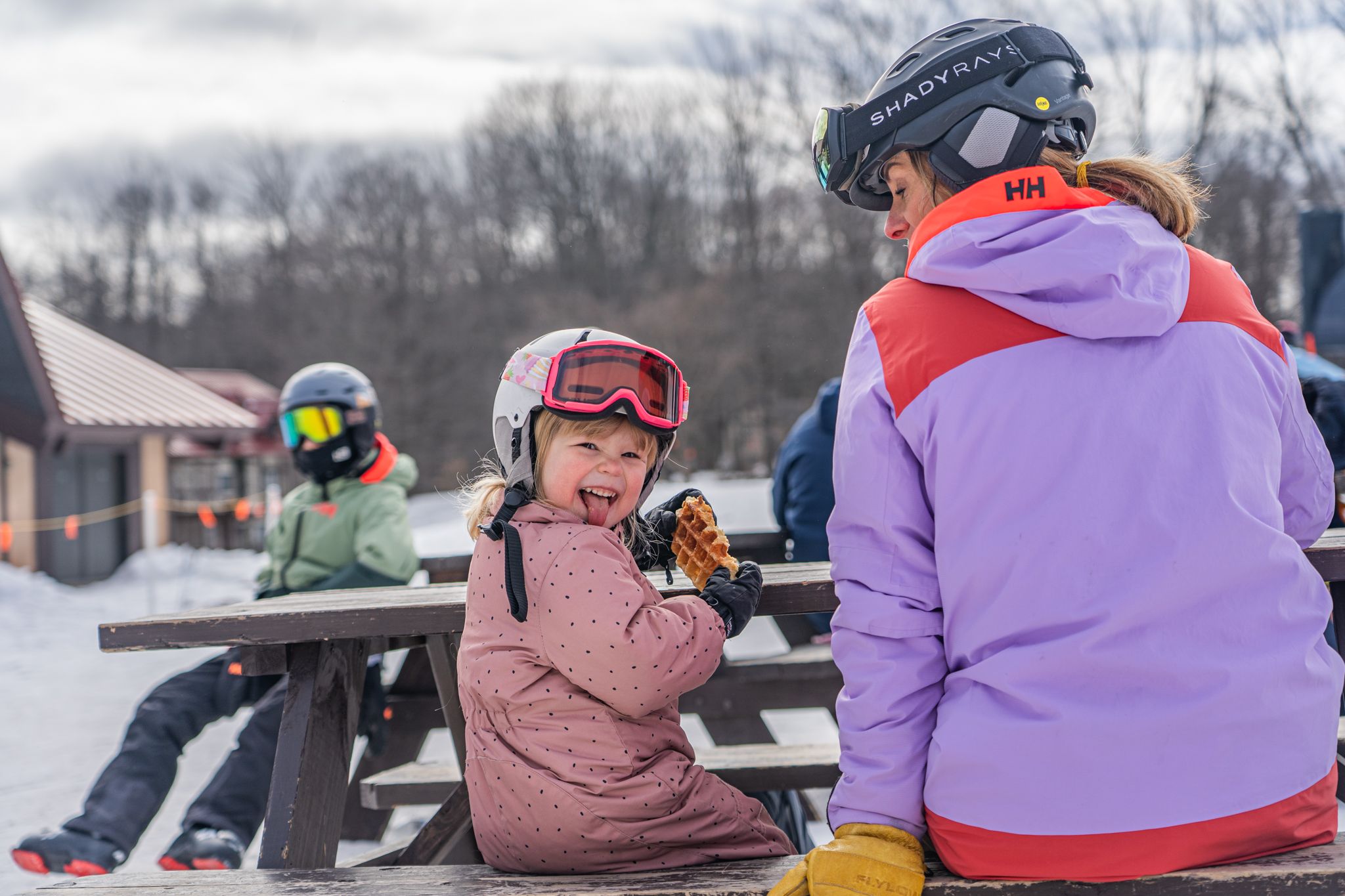 little girl eating Waffle Cabin sticking out tongue