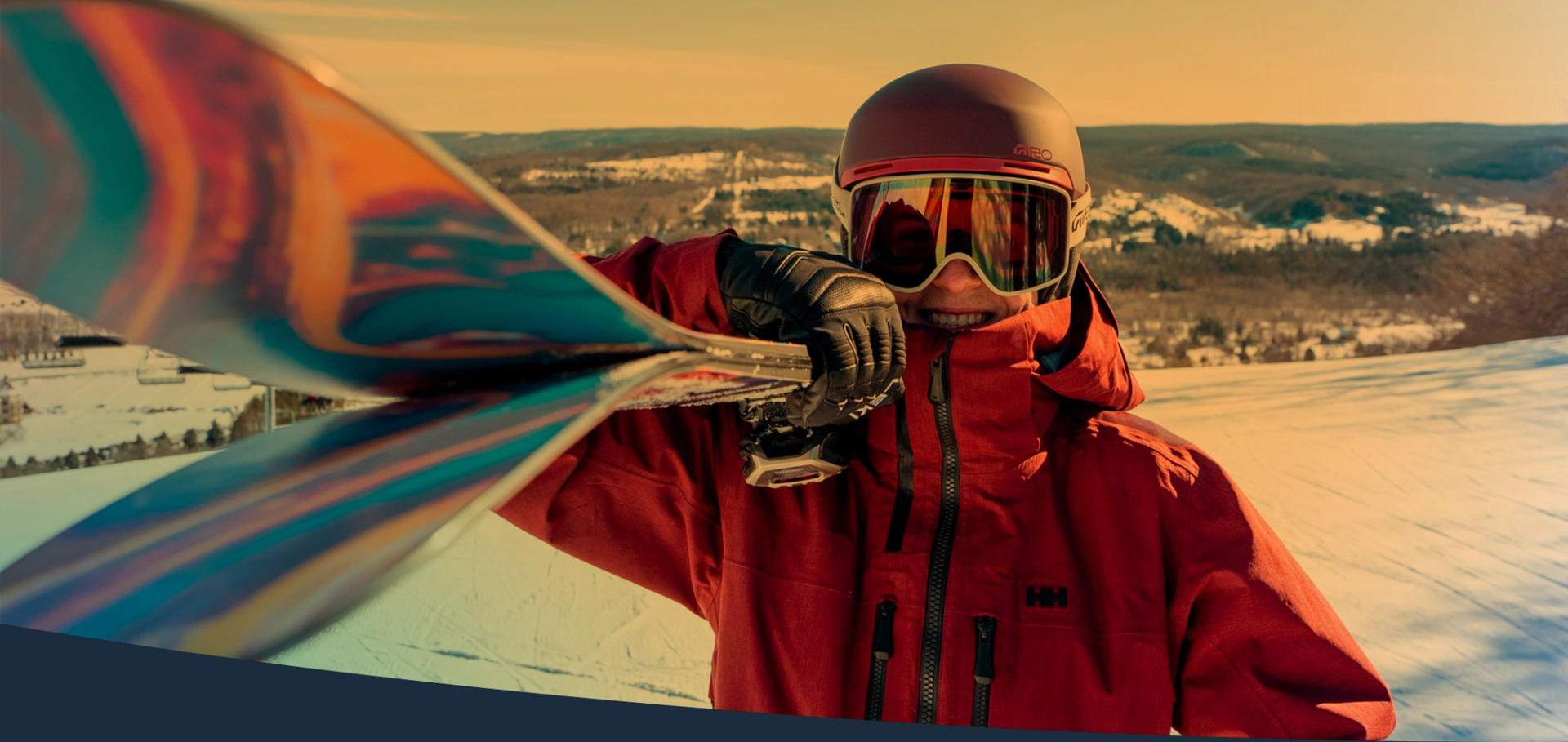 skier walking with skis on shoulder