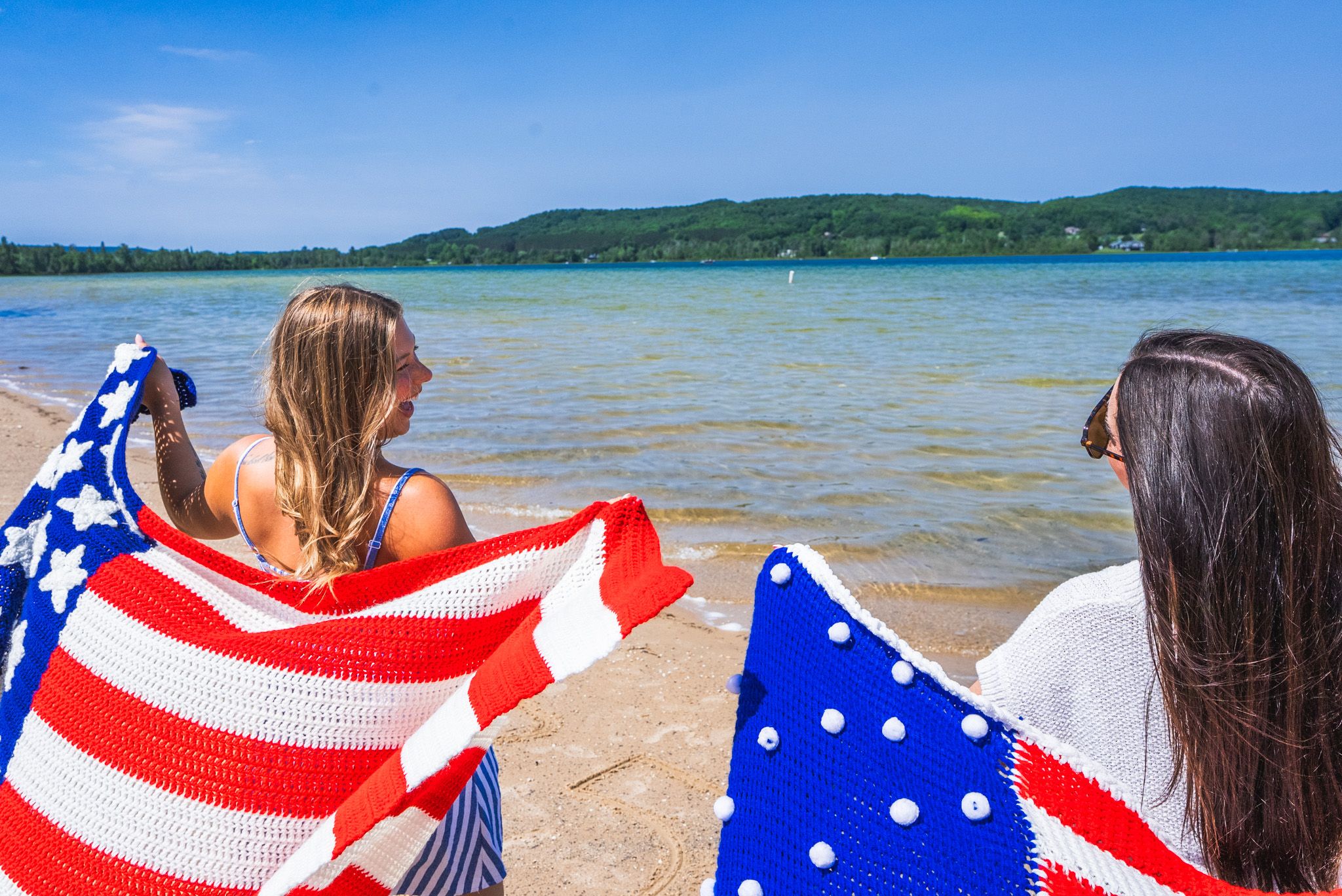 girls with american flags at the beach