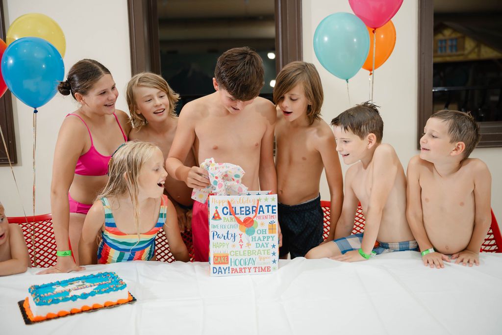 Kids with cake and a birthday present