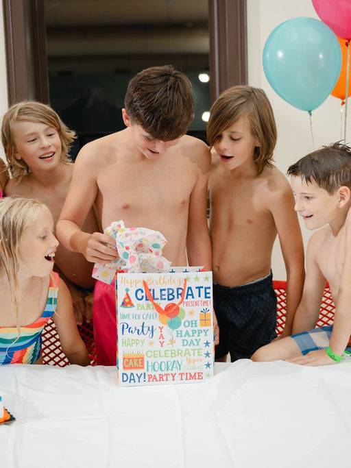 Kids with cake and a birthday present