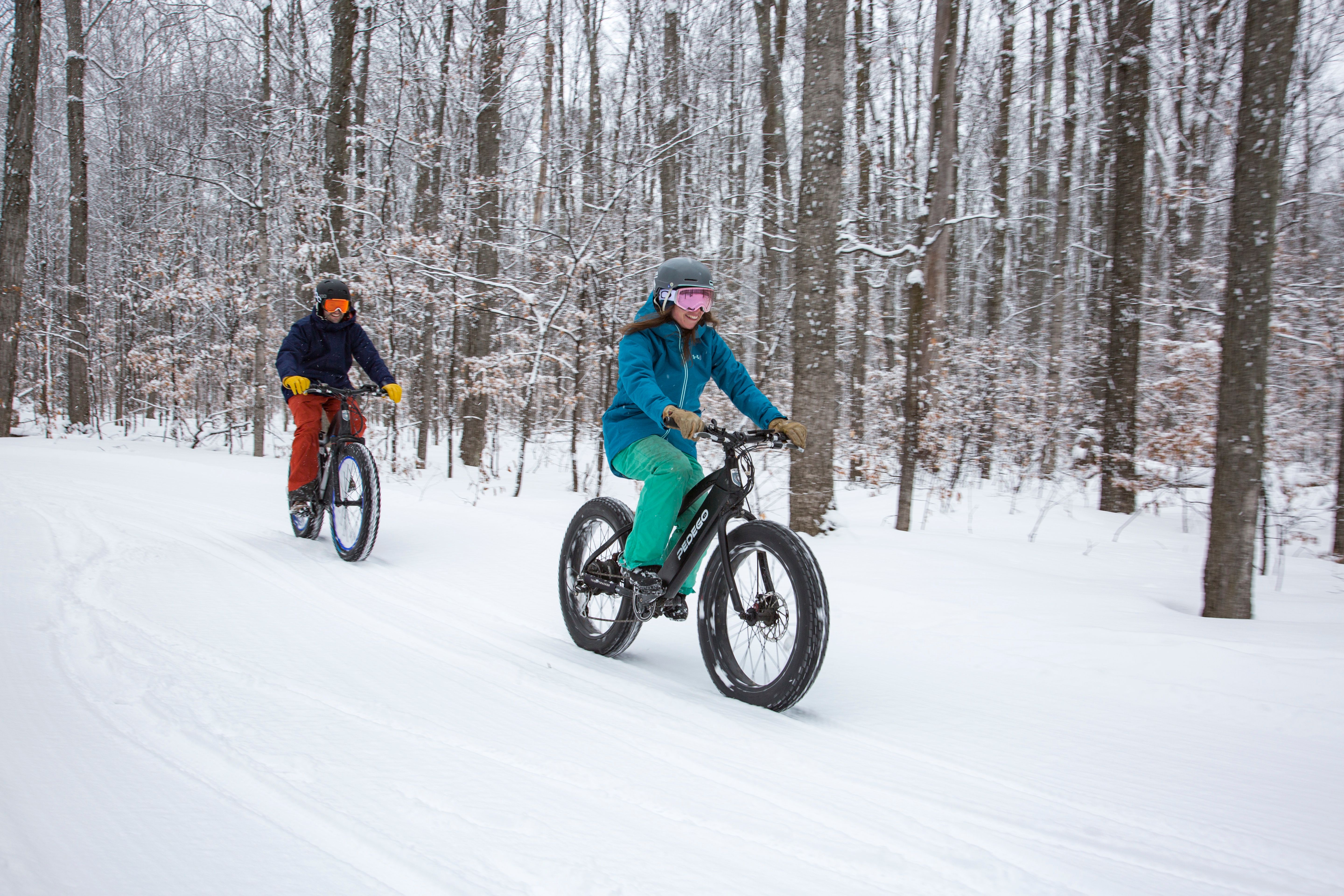Couple on fat tire bikes on a snowy trail