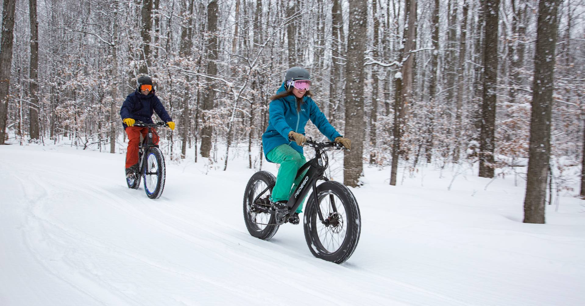 Couple on fat tire bikes on a snowy trail