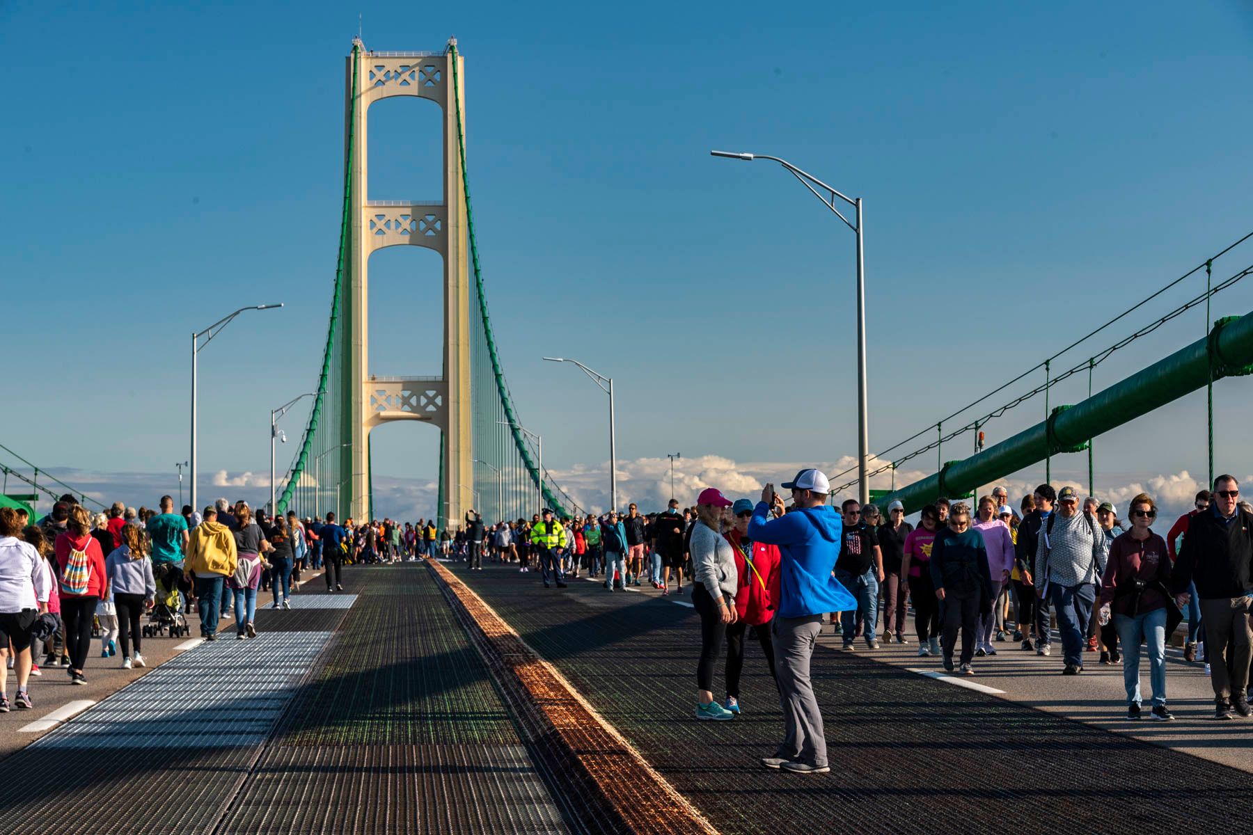 Group of people walking across the Mackinac Bridge 