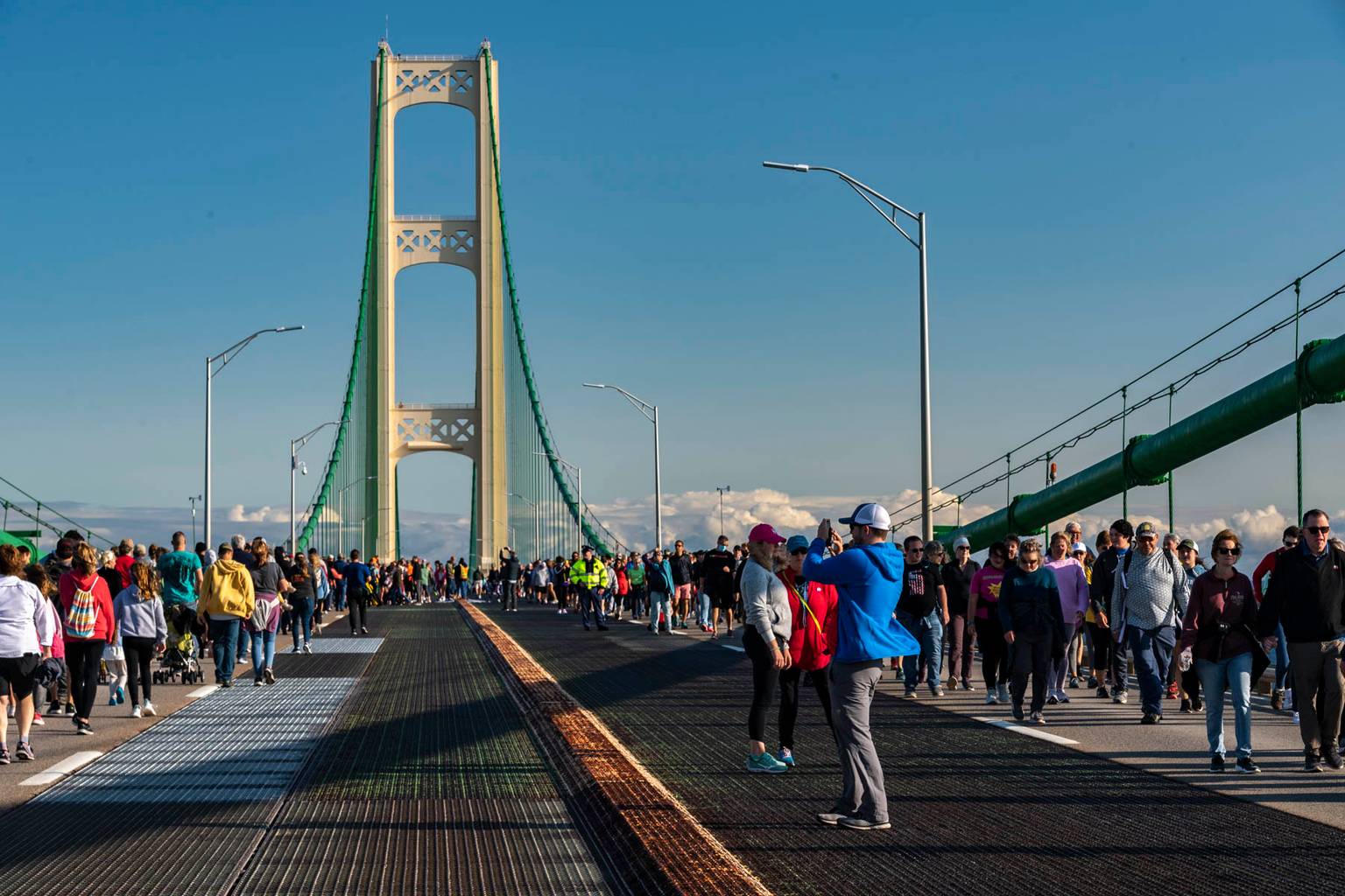 Group of people walking across the Mackinac Bridge