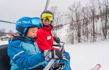 child and instructor on chairlift