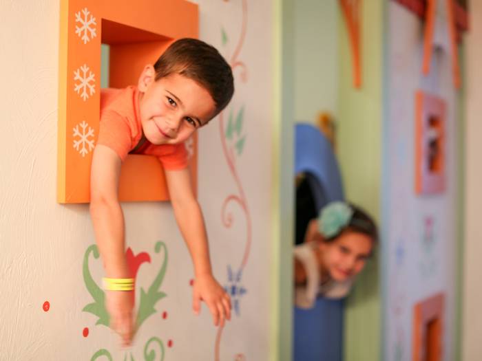 kids hanging out of kids room windows in a resort suite