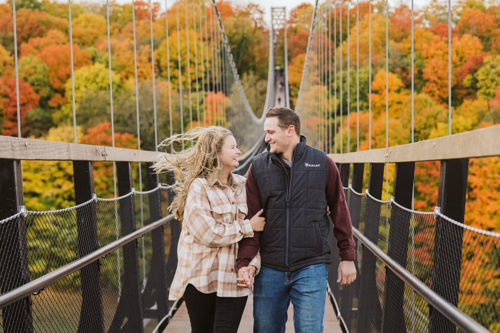 couple on skybridge during peak fall colors