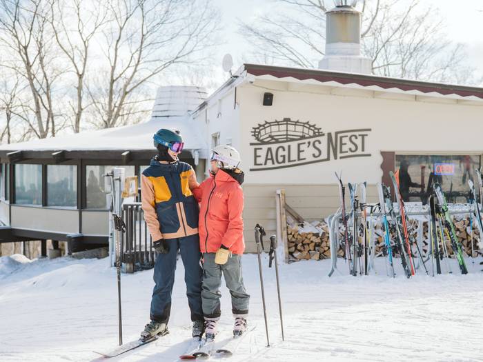 Couple on skis outside Eagle's Nest.