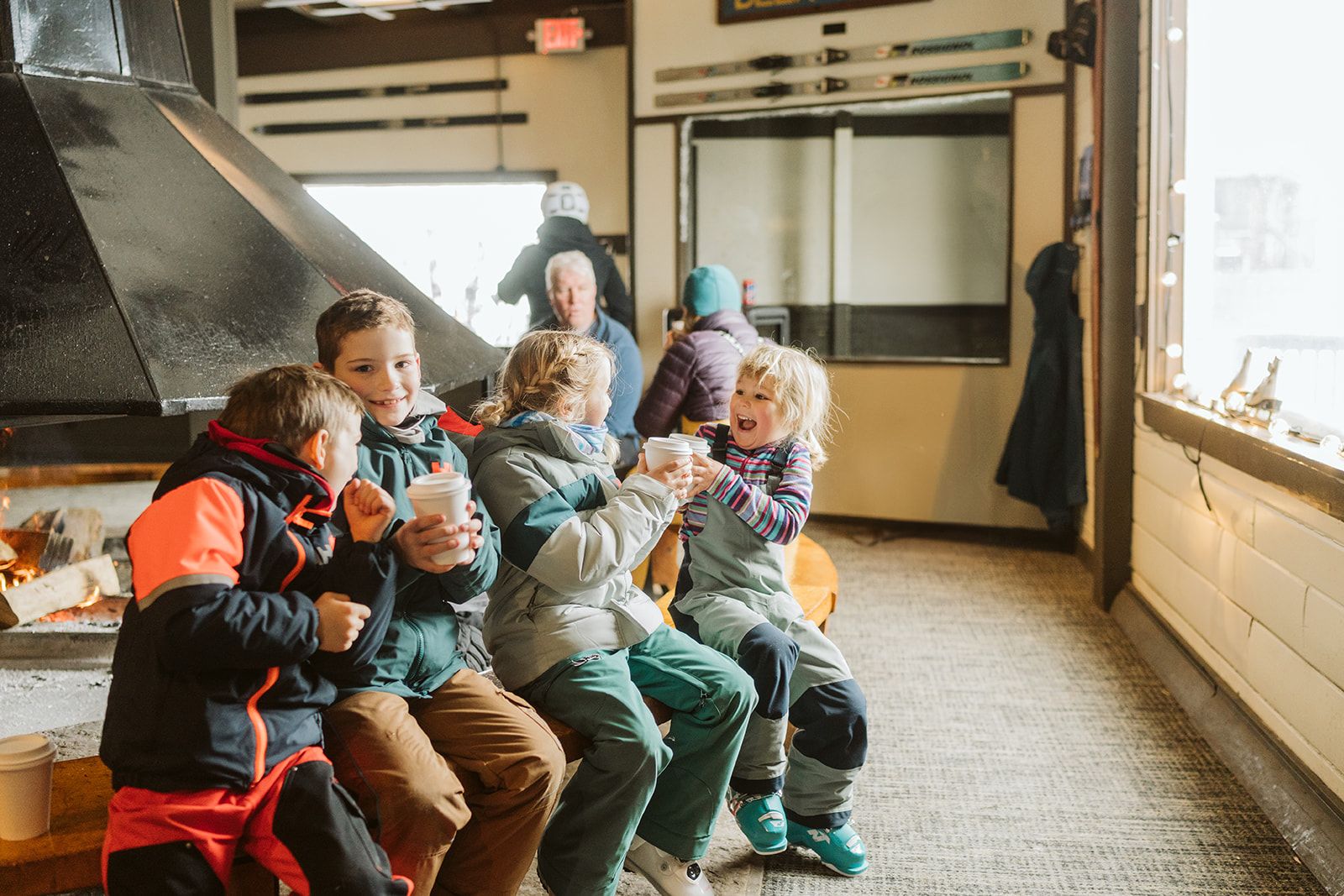 Kids sitting by the fire inside Eagle's Nest