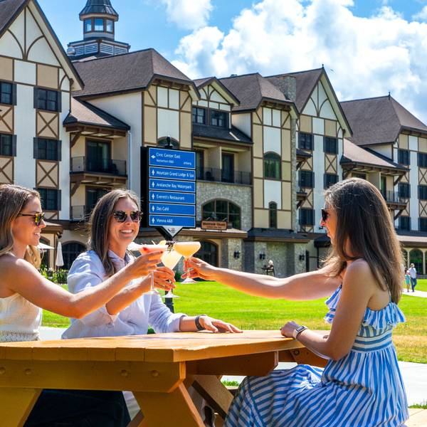 Women toasting drinks at the base of Boyne Mountain.