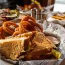 Loaded grilled cheese sandwich with onion rings at Forty Acres Tavern