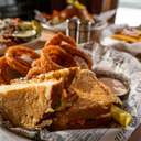 Loaded grilled cheese sandwich with onion rings at Forty Acres Tavern