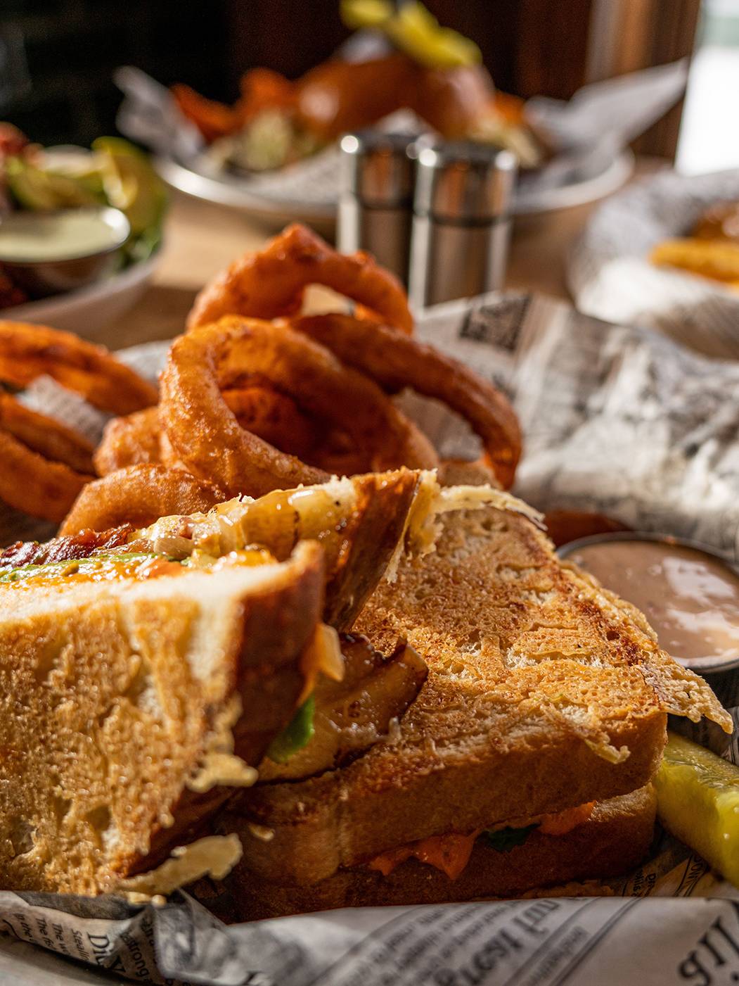 Loaded grilled cheese sandwich with onion rings at Forty Acres Tavern
