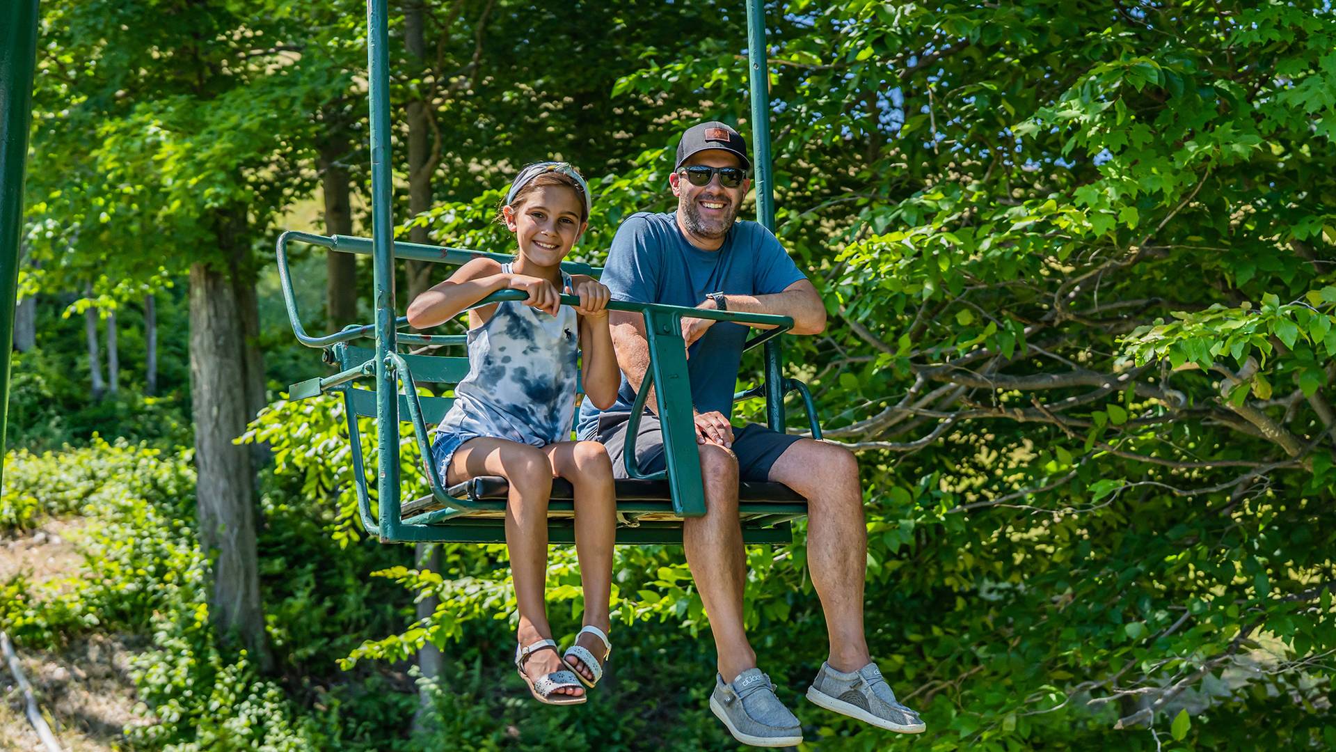 Daughter and dad on scenic chairlift