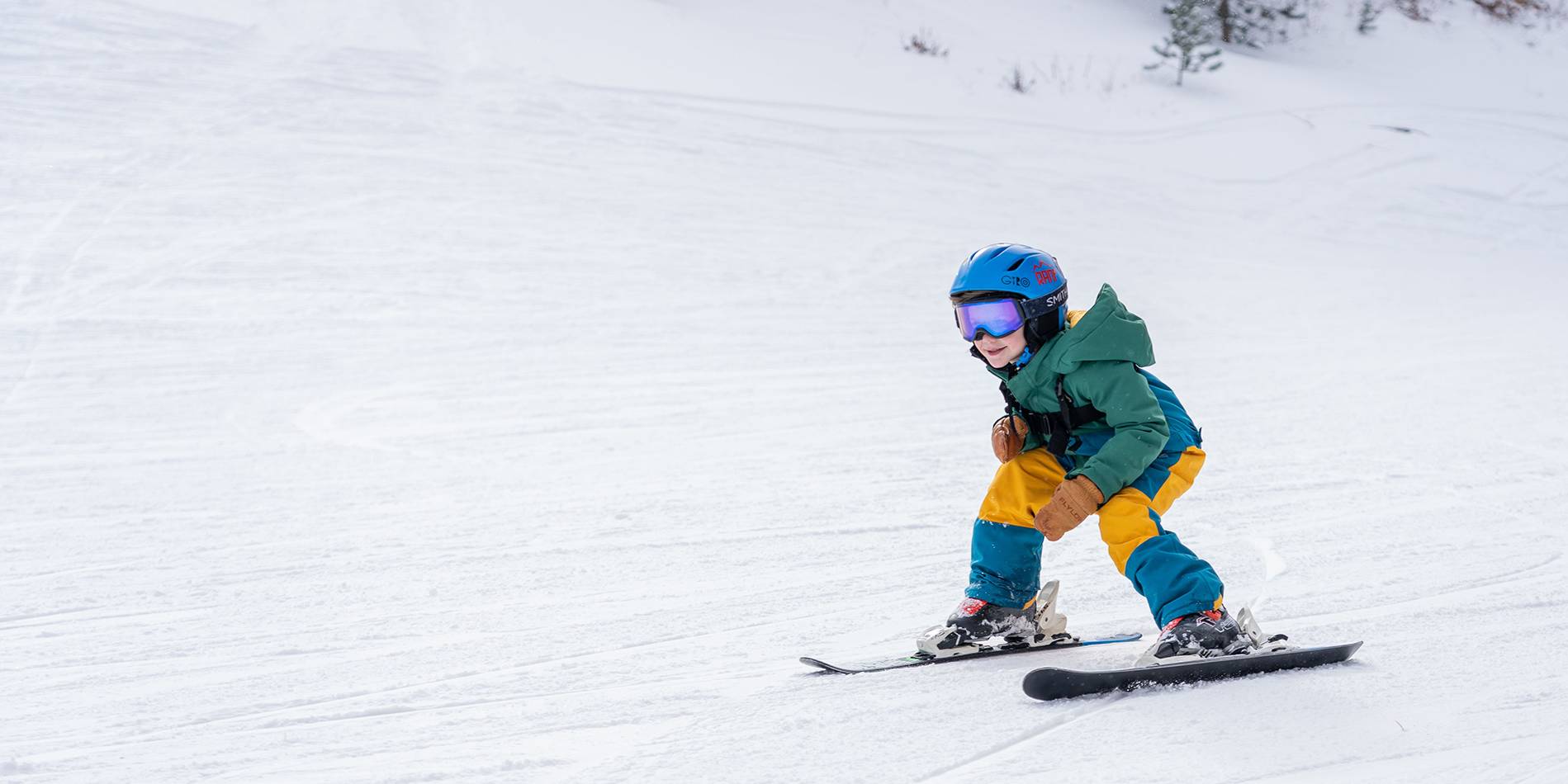 Young boy shredding down the ski hill